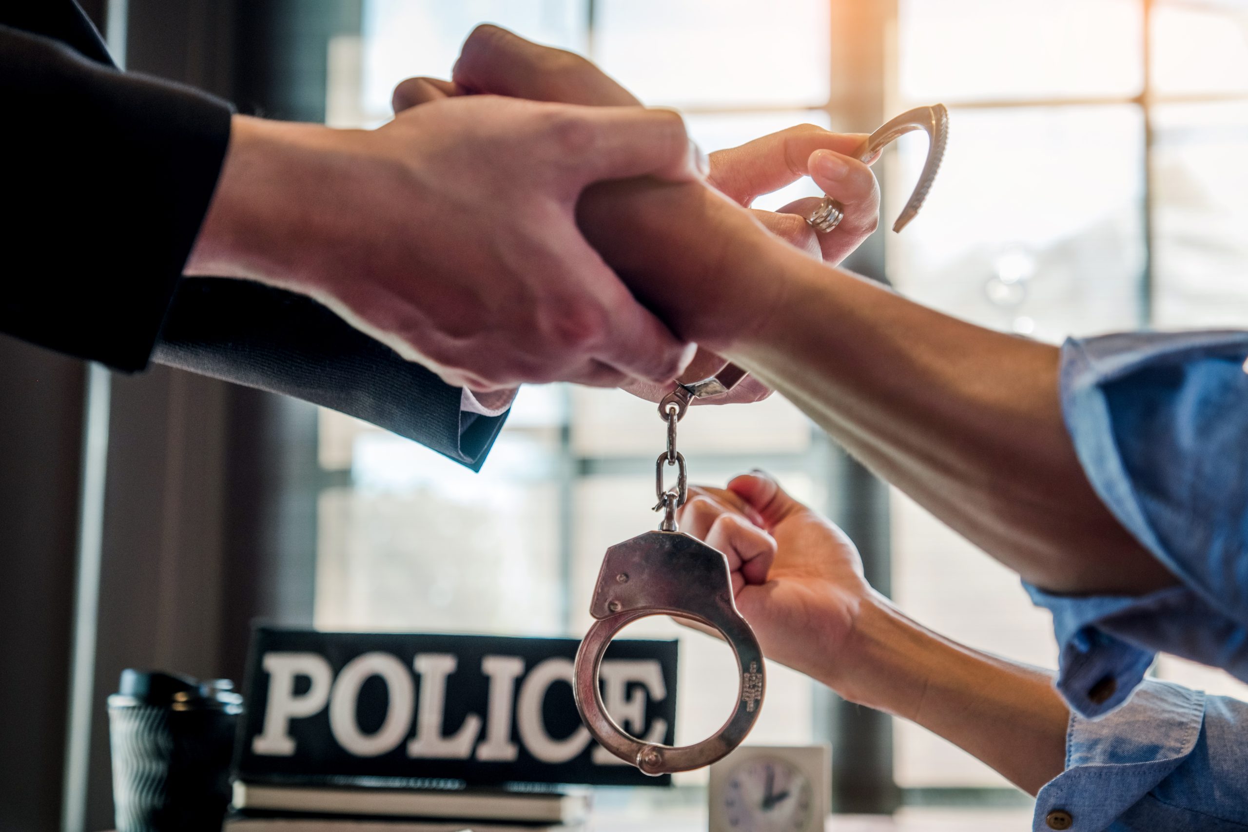 Law enforcement officer interrogating Criminals male with handcuffs in the investigation room Police officer interviewing after committed a crime
